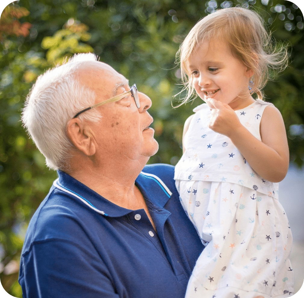 Man In Blue Polo Shirt Carrying Girl In White And Pink Floral Dress