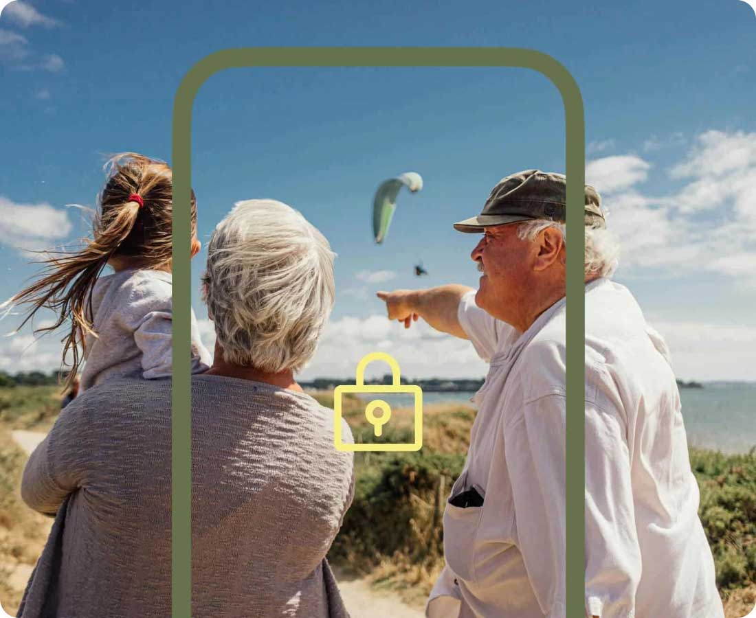 Older Couple With Little Girl At The Beach Watching Parachutes Landing