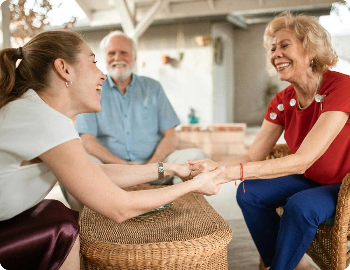 Older Woman And Younger Woman Holding Hands