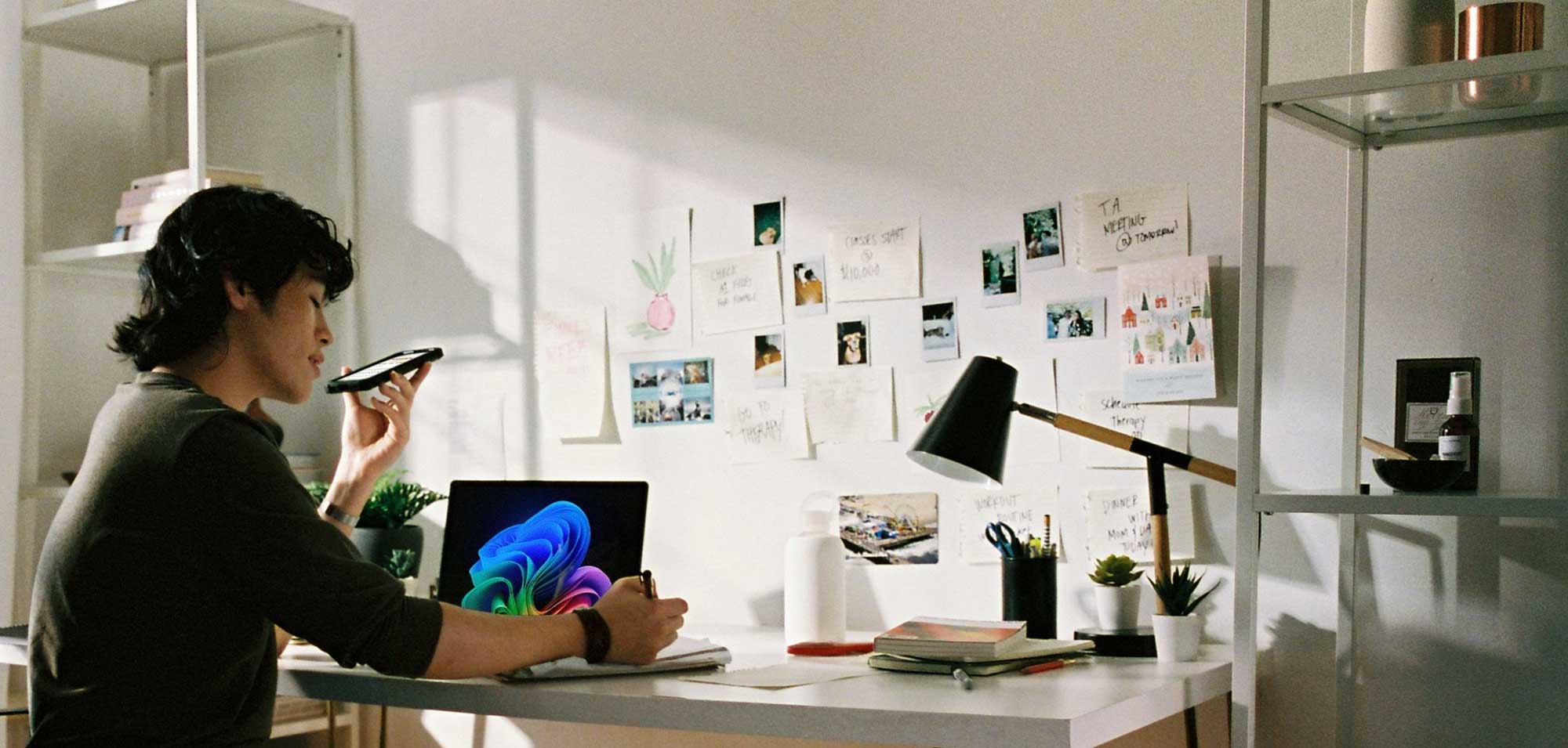 Person Working At Desk With Laptop And Phone