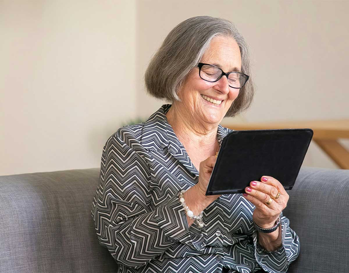 Woman Smiling Watching Tablet